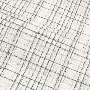 Detailed macro view of black and white plaid tweed fabric with tiny metallic sequins