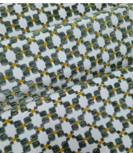 Macro view of vintage green jacquard fabric with textured floral pattern for upholstery