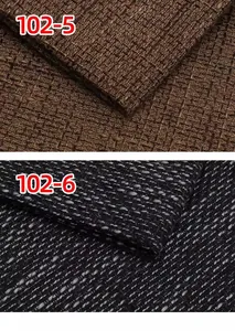 Close-up detail of thickened coarse linen fabric in brown and black tones.