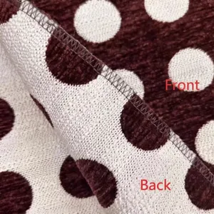 Macro detail of thick burgundy polka dot chenille fabric showing front and back texture
