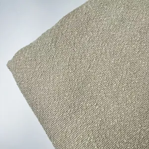 Close-up macro detail of thickened beige bouclé yarn fabric with rich looped texture