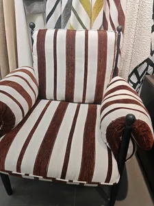 Close-up view of vintage brown and white striped chenille upholstery fabric on an armchair