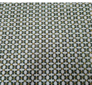 Close-up of vintage green jacquard fabric with geometric pattern for upholstery