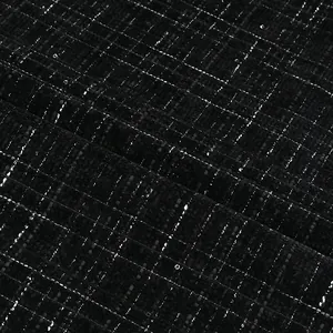 Close-up of black tweed fabric with metallic silver plaid pattern for dresses