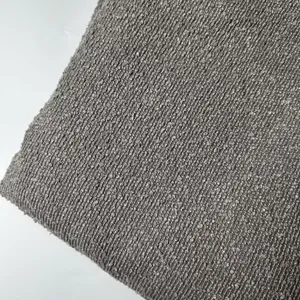 Detailed macro shot of thick grey boucle yarn fabric with rich teddy hemp texture