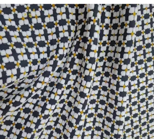 Macro view of vintage style jacquard fabric featuring black, white and gold geometric patterns