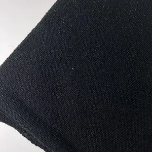 Close-up macro view of thick black bouclé loop yarn fabric with rich texture and tight weave