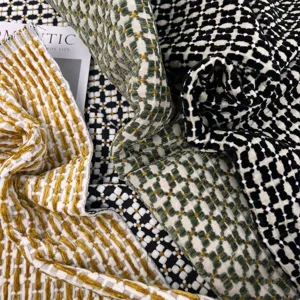 Close-up detail of vintage green and gold jacquard fabric with premium textured patterns