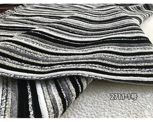 Detailed macro view of black and white striped chenille fabric with textured 3D velvet ribs