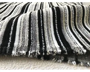 Detailed macro shot of black and white striped chenille fabric for luxury upholstery