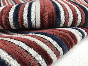 Macro view of high-quality textured chenille upholstery fabric with red and blue stripes