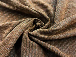 Macro detail of textured chenille fabric featuring a vintage brown and blue twill weave pattern