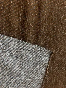 Detail shot of heavy chenille tweed fabric with large twill weave showing front and back texture.