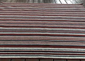 Detailed view of striped chenille corduroy fabric in brown, white and navy blue
