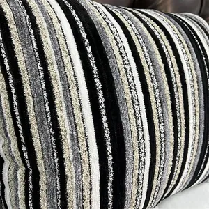 Macro view of textured chenille upholstery fabric with black and white vertical stripes