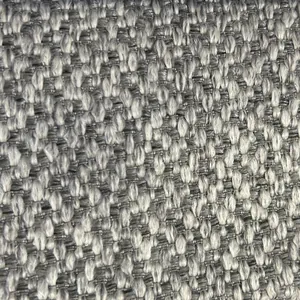 Primer plano de tela de lino gruesa gris y beige con textura de tejido grueso para sofás.