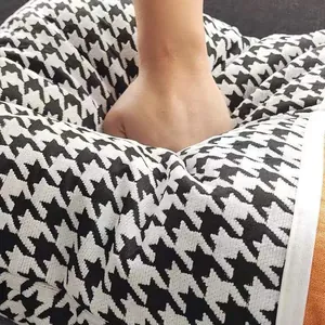 Close-up detail showing the soft texture and resilience of houndstooth chenille fabric