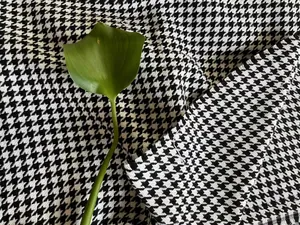 Macro view of classic black and white houndstooth chenille fabric for home upholstery
