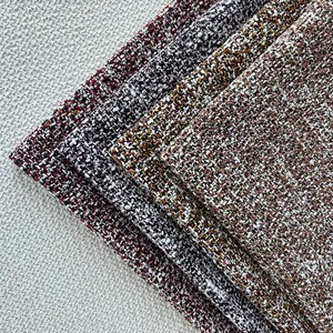 Detailed macro view showing the coarse texture of layered bouclé tweed fabrics in various colors