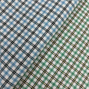 Detailed macro view of blue and green plaid polyester upholstery fabric texture