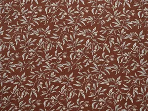 Detail shot of vintage botanical chenille jacquard fabric with leaf and berry pattern
