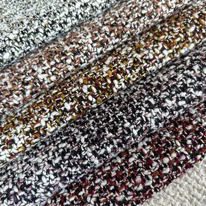Macro close-up showing textured patterns of multi-colored tweed burlap fabric rolls