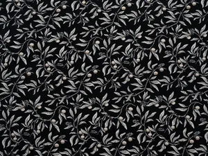 Close-up detail of vintage botanical jacquard fabric with black and white leaf pattern