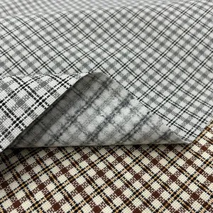 Macro view of grey and brown checkered polyester fabric showing detailed weave texture