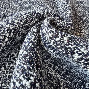 Detailed macro view showing the thick texture of navy blue and white woven tweed fabric