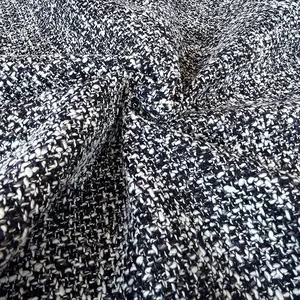 Detailed close-up of premium black and white textured tweed fabric for cushions and sofa upholstery