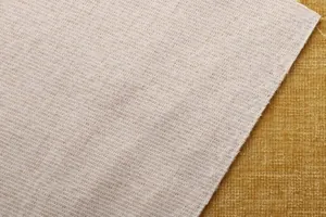 Detalle en primer plano de tela de chenilla lisa con textura de lino