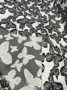 Détail du tissu jacquard chenille papillon 3D avec motif de fleurs coupées texturé
