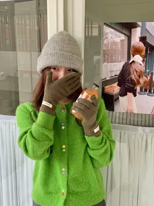 Close-up lifestyle view of model wearing soft 100% wool knit gloves for winter warmth