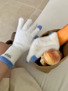 Close-up of ultra-soft white and blue fuzzy gloves with touchscreen compatible fingertips