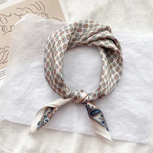 Close-up view of a French vintage paisley silk scarf featuring an elegant knotting detail