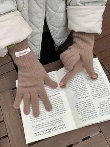 Close-up of brown merino wool knitted gloves with 100% wool label detail