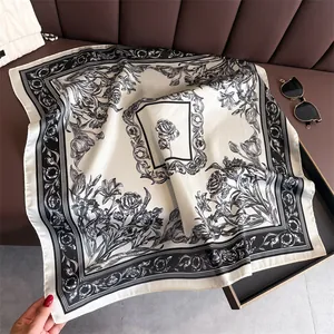 Close-up of French retro floral square scarf with intricate black and white patterns