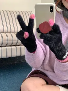 Close-up view of soft black coral fleece gloves with pink touch-screen finger openings