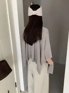 Vista posteriore dettagliata di uno scialle in maglia grigio retrò per l'inizio dell'autunno.