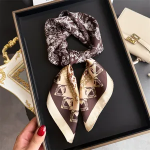 High-end detail view of a French retro paisley pattern silk scarf in a dark display box