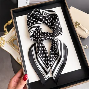 Close-up detail of a French vintage polka dot and striped silk scarf for women's fashion accessory