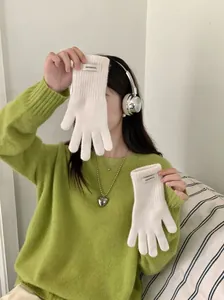 Asian female model wearing soft cream white 100% wool knit gloves for winter warmth