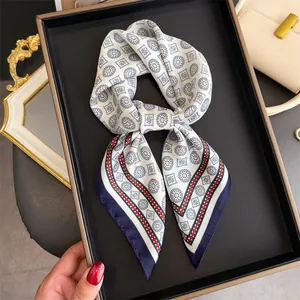 Detail of French vintage silk scarf with paisley geometric pattern in navy and red