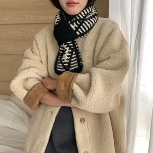 Cozy black and white striped knit cross-over scarf with warm and soft texture