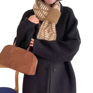 Fashionable knitted crossover scarf with geometric striped pattern in brown and beige colors