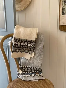 Detail of vintage Fair Isle knitted scarves with Nordic patterns in a cozy setting