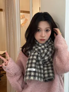 Detailed view of a cozy black and white checkered knitted scarf for winter styling