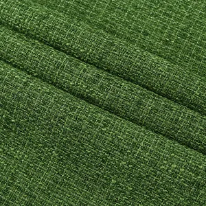 Detailed close-up view of dark green bouclé tweed fabric with shimmering silver threads