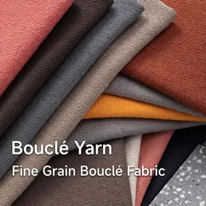 Close-up detail showing bouclé yarn and small grain linen fabric for sofa upholstery