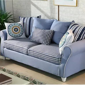 Detail view of fresh blue checkered sofa fabric and various decorative accent pillows